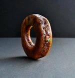 Hand-carved antique Tibetan kapala skull amulet centerpiece on a weathered 108 Bodhi seed prayer mala.
