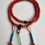 Hand-polished red coral prayer beads featuring natural turquoise spacers.