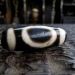 Ancient-style Dzi bead with traditional etched eye patterns.