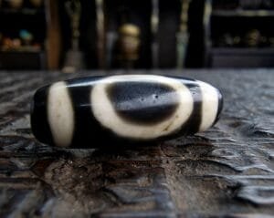 Ancient-style Dzi bead with traditional etched eye patterns.