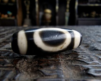 Ancient-style Dzi bead with traditional etched eye patterns.