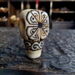 Hand-carved ivory-tone bone guru bead with smooth ritual patina.