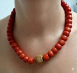 Hand-polished antique coral beads with authentic gold spacers and ritual patina.
