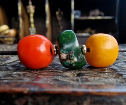 Hand-polished necklace featuring natural red coral, blue turquoise, and honey amber.