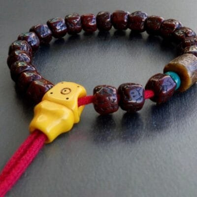 Natural Rudraksha seeds paired with hand-carved bone Kapala skulls.