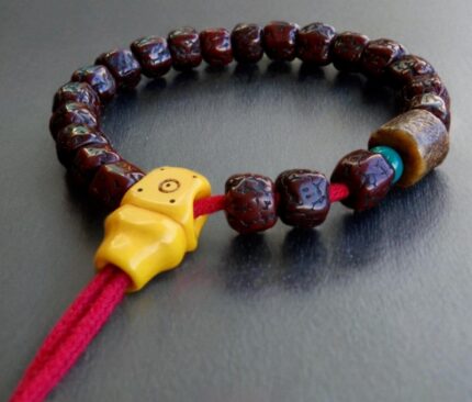 Natural Rudraksha seeds paired with hand-carved bone Kapala skulls.