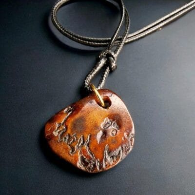 Hand-carved Tibetan Kapala skull amulet with an aged bone patina.