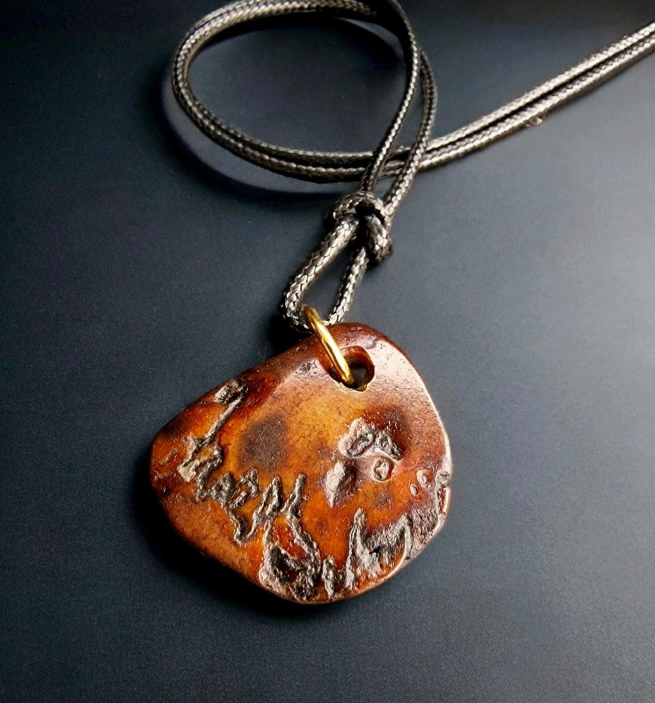 Hand-carved Tibetan Kapala skull amulet with an aged bone patina.