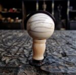 Hand-carved ivory-tone bone guru bead with a smooth ritual patina.
