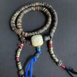 Hand-carved Kapala bone mala adorned with natural coral and turquoise.