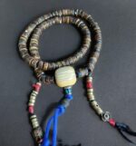 Hand-carved Kapala bone mala adorned with natural coral and turquoise.