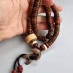 Hand-carved Kapala bone prayer beads in a full 108-count ritual mala.