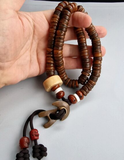 Hand-carved Kapala bone prayer beads in a full 108-count ritual mala.