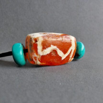 Hand-etched antique Chong Dzi bead with traditional linear patterns.