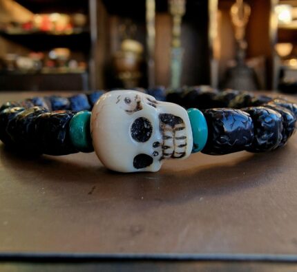 Natural Rudraksha seeds paired with hand-carved bone Kapala skulls.