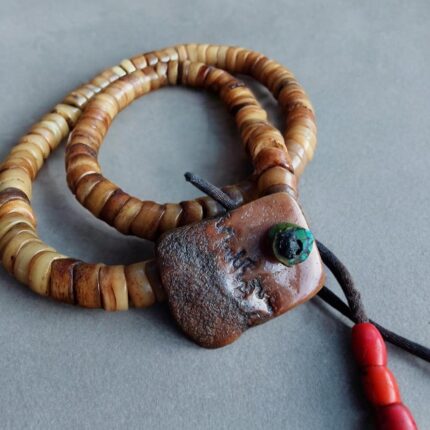 Hand-carved bone prayer beads featuring a detailed Kapala skull pendant.