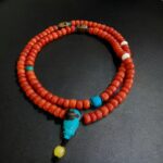 Hand-strung coral prayer beads featuring a rich red hue and traditional ritual spacing.