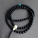 Hand-knotted Tourmaline Mala necklace featuring 108 multi-colored gemstone beads and a Tibetan Turquoise guru.