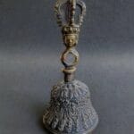 Hand-cast Tibetan bronze Ghanta bell featuring intricate ritual carvings and a vajra handle.