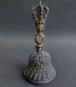 Hand-cast Tibetan bronze Ghanta bell featuring intricate ritual carvings and a vajra handle.