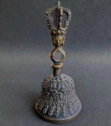 Hand-cast Tibetan bronze Ghanta bell featuring intricate ritual carvings and a vajra handle.