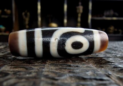 Hand-etched 2-eye Dzi bead featuring traditional sacred geometry.