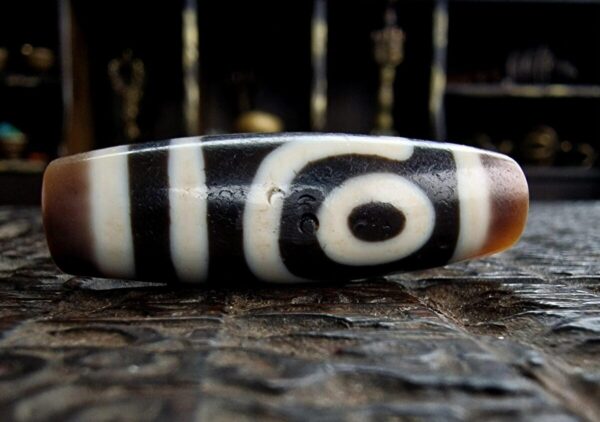Hand-etched 2-eye Dzi bead featuring traditional sacred geometry.