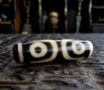 Authentic Tibetan 3-Eye Dzi bead featuring clear circular motifs on high-quality etched agate.