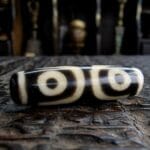 Authentic Tibetan 3-Eye Dzi bead featuring clear circular motifs on high-quality etched agate.