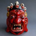 Hand-carved Tibetan Mahakala mask featuring a wrathful expression and a crown of five skulls.