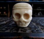Antique Tibetan Guru bead with a rich ritual patina and traditional two-part construction.