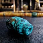 Hand-carved turquoise Guru bead set featuring a natural blue-green matrix.