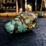 Hand-carved turquoise Guru bead set with a natural blue-green matrix and ritual hole.