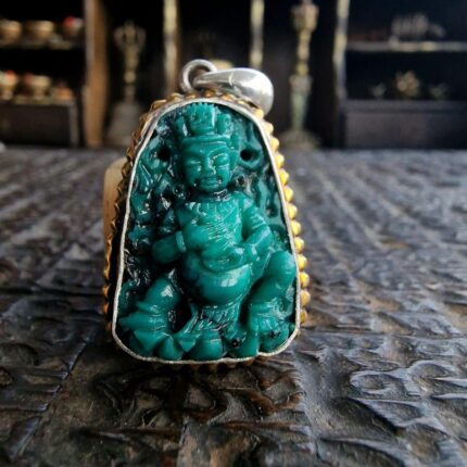 Hand-carved antique Tibetan Buddha sculpture crafted from a single piece of genuine turquoise.