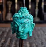 Hand-carved genuine turquoise Buddha head focal bead showing natural blue-green matrix.