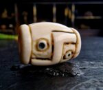 Hand-etched Dzi bead with ivory-toned patina featuring traditional sacred geometry.