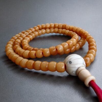 Authentic Yak Bone Mala with 108 hand-carved beads showing a deep, aged ritual patina.