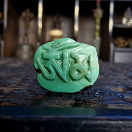 Tibetan turquoise Om Mani carving antique mantra stone with hand-carved Tibetan script.