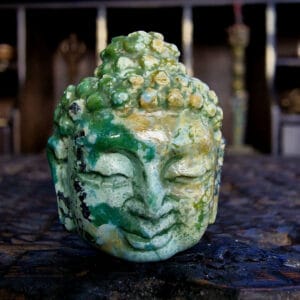 Himalayan moss turquoise Buddha bead hand-carved with natural green and ochre mineral inclusions.